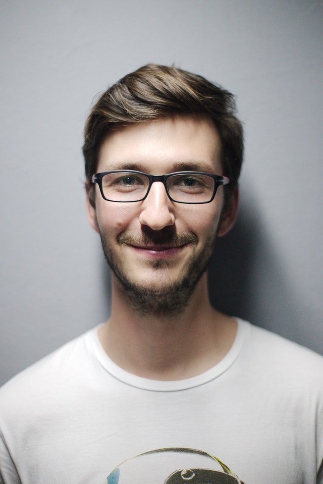 Boy in a white t-shirt wearing glasses