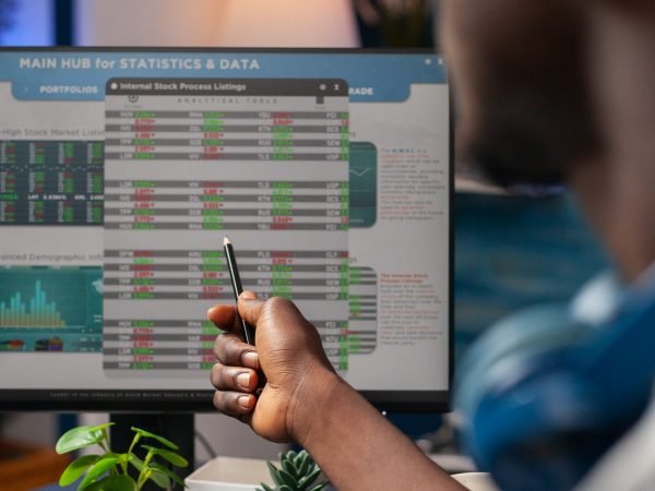 Young business man analyzing stock market value