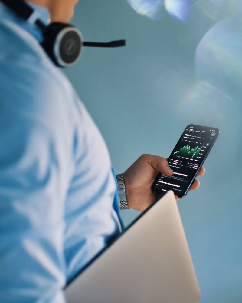 Business man checking stock market on mobile phone