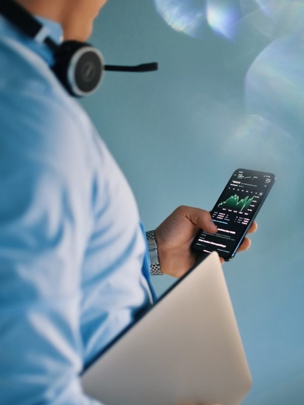 Business man checking stock market on mobile phone