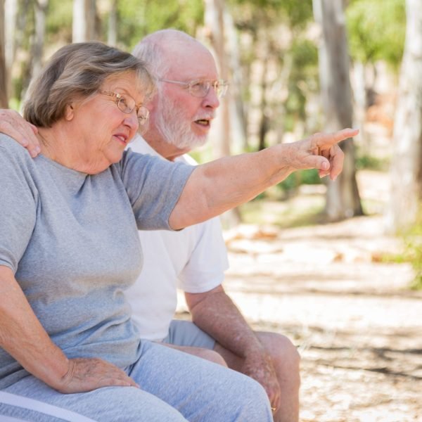 Senior Couple Enjoying The Outdoors At Park. Old Age Couple