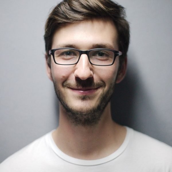 Boy in a white t-shirt wearing glasses
