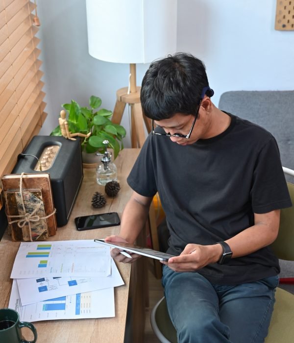Young man analyzing graph stock market trading on digital tablet.